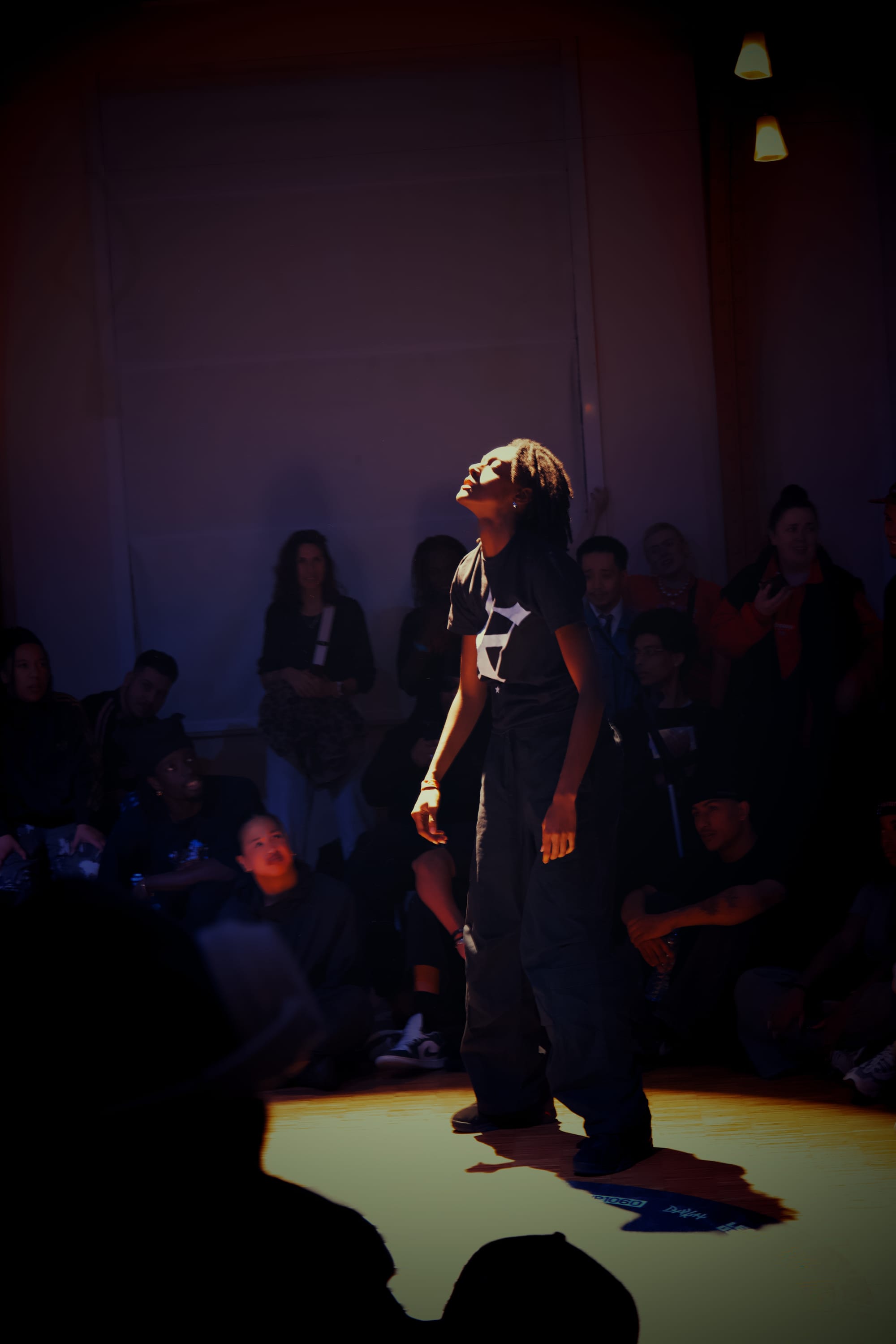 Twinn Zepek is in the middle of the dancefloor with her eyes closed and her head tilted 45 degrees towards the ceiling.