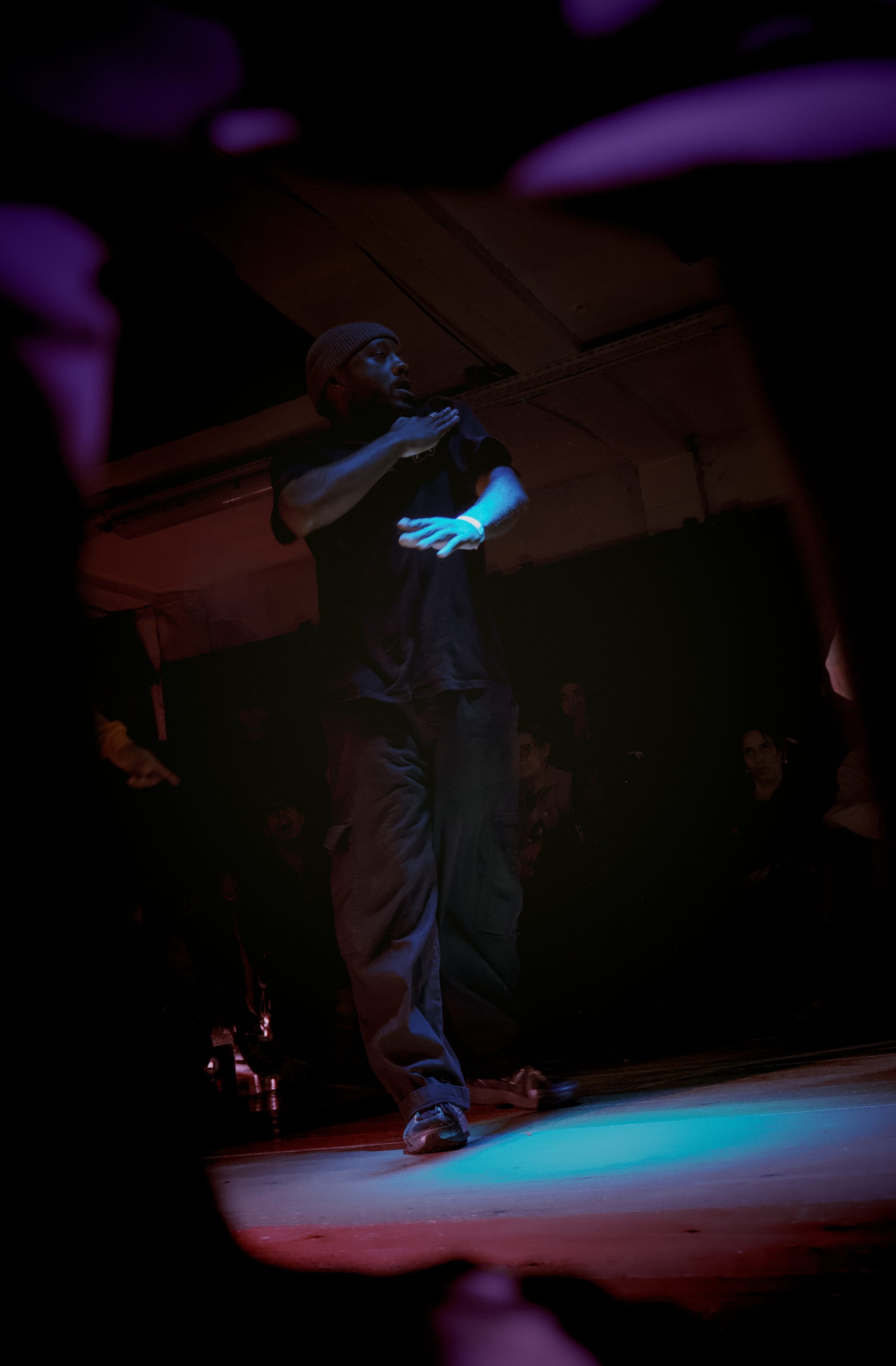 Serge touches his left shoulder with his right hand.